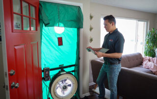 A technician conducting a blower door test.