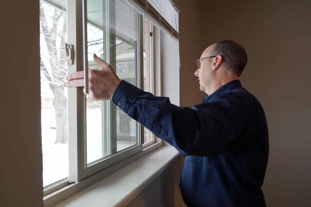 home inspector inspecting a window