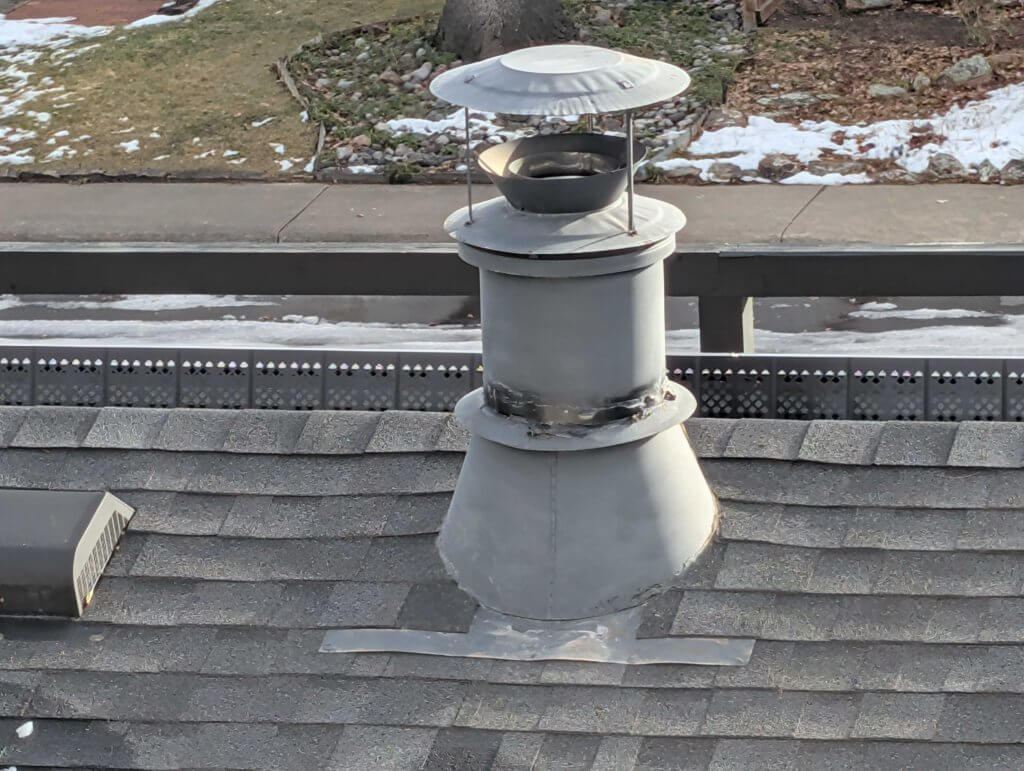 Chimney without a spark arrestor, showing an exposed flue opening with no protective mesh or cap.