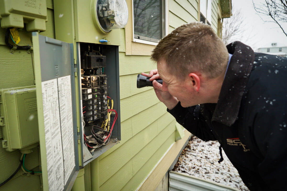 Electrical panel inspection during a one year warranty inspection